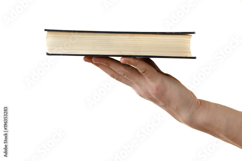 human hand holding black book isolated on white background photo