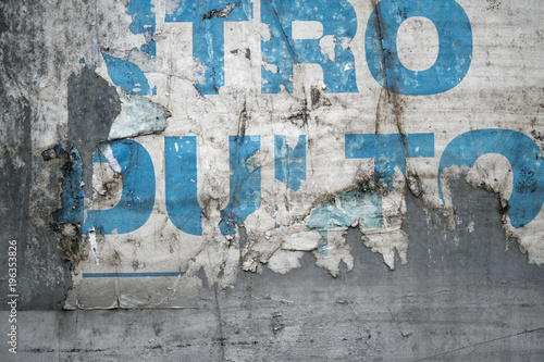 Torn poster after vote on tin textured wall. Ripped newspaper