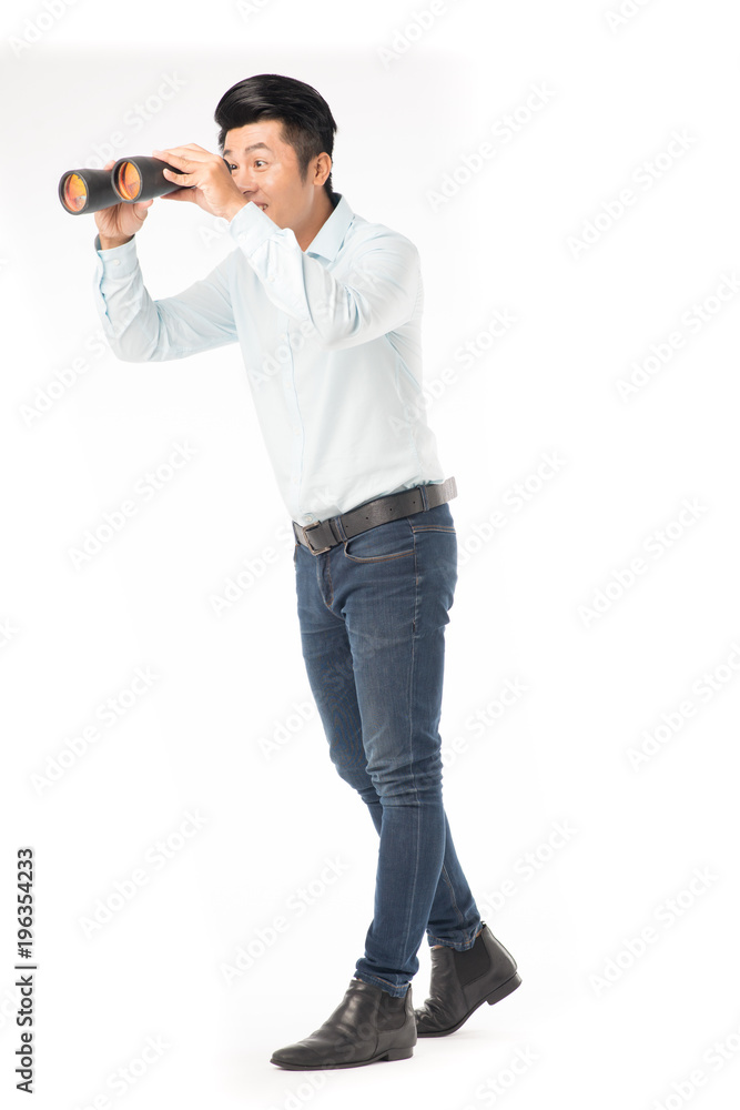 Young Asian man enjoying looking through binoculars Young Asian man enjoying looking through binoculars