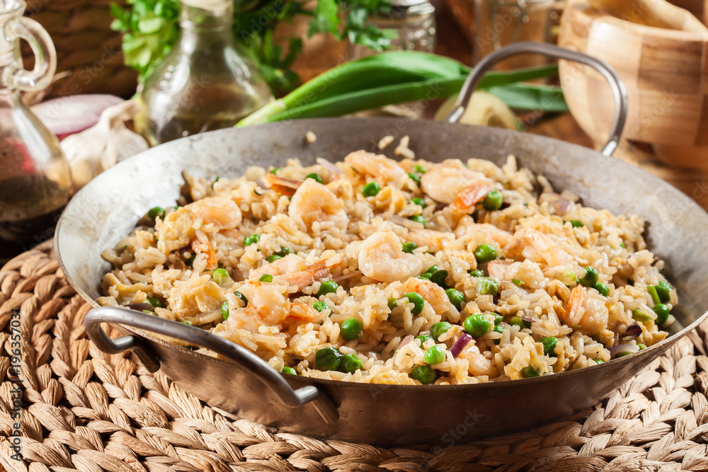 Fried rice with shrimp and vegetables on a frying pan Fried rice with shrimp and vegetables on a frying pan