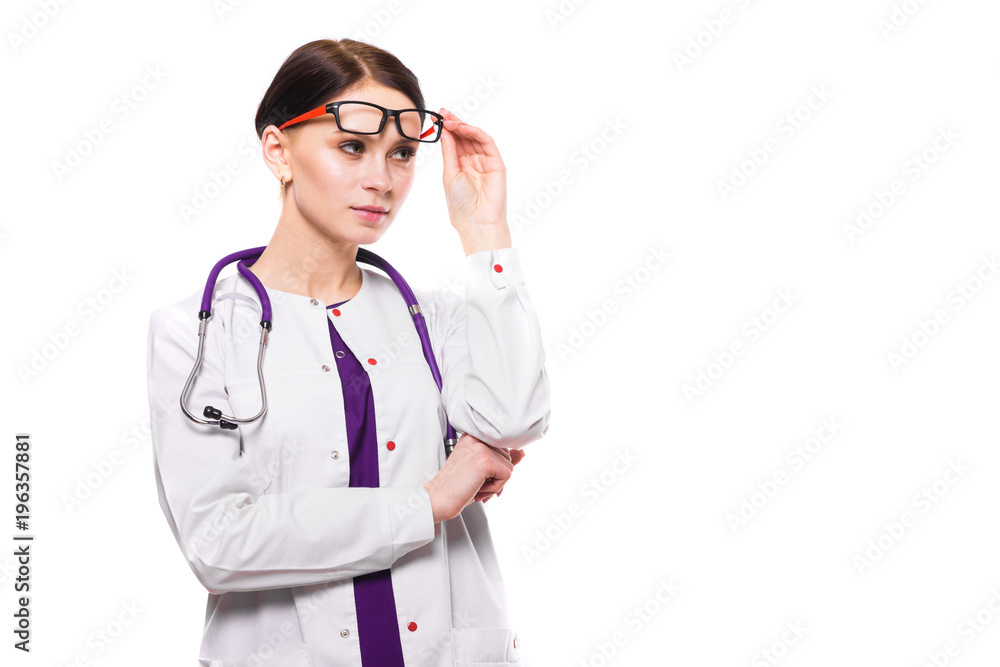 Young beautiful female doctor with raised glasses on white background Young beautiful female doctor with raised glasses on white background