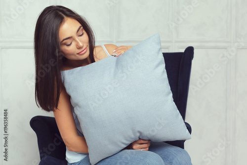 Happy smiling woman holding pillow