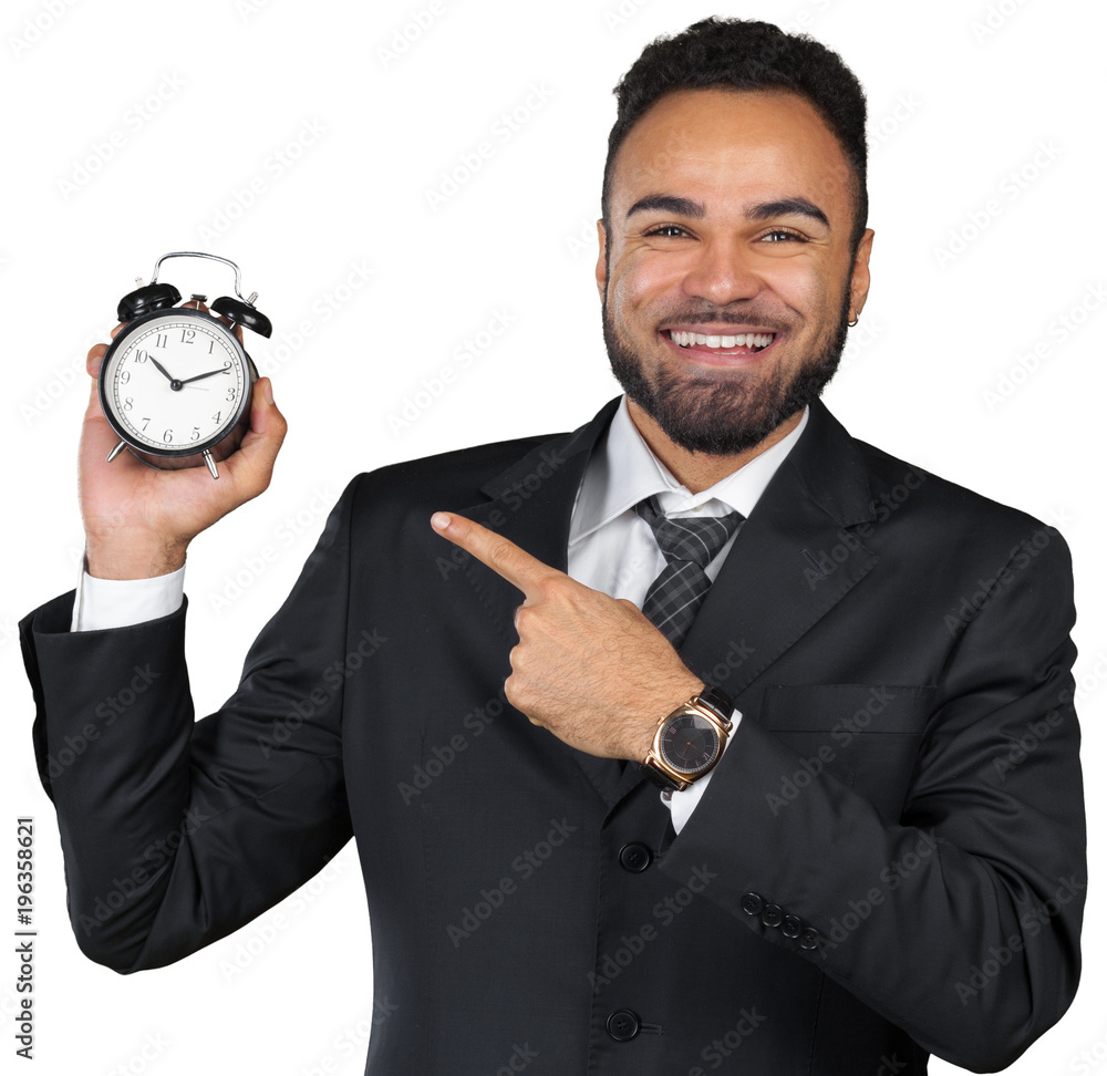Young businessman holding alarm clock isolated on white Young businessman holding alarm clock isolated on white