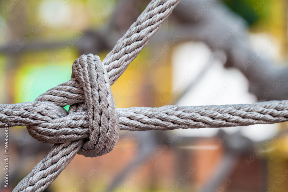 Close-up of rope knot line tied together with playground background.selective focus.