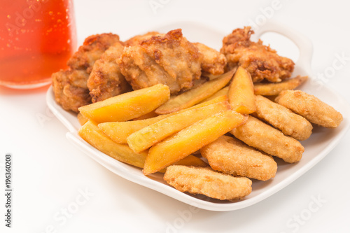 Chicken nuggets and ice tea on white background