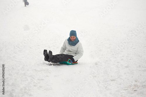 Belarus, Grodno, Lake Molochnoe in the winter. People sledding on the slides.