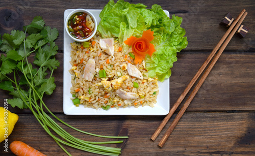  chicken fries rice on wooden background with top view photo