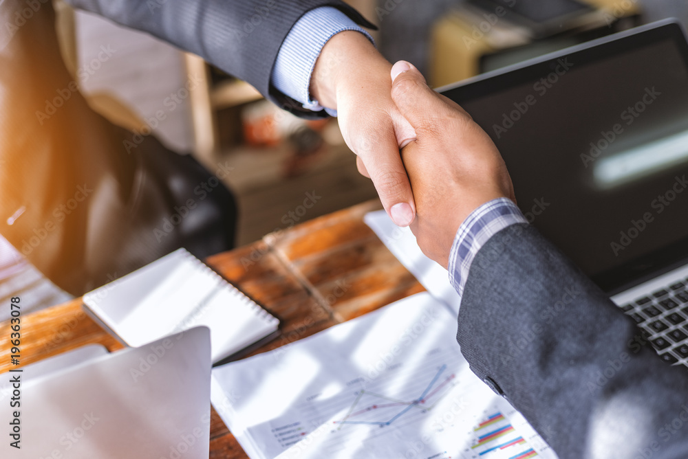Naklejka premium Business handshake and business people at office desk. teamwork workplace strategy Concept.