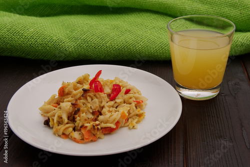 Pasta with vegetables and cheese on a table