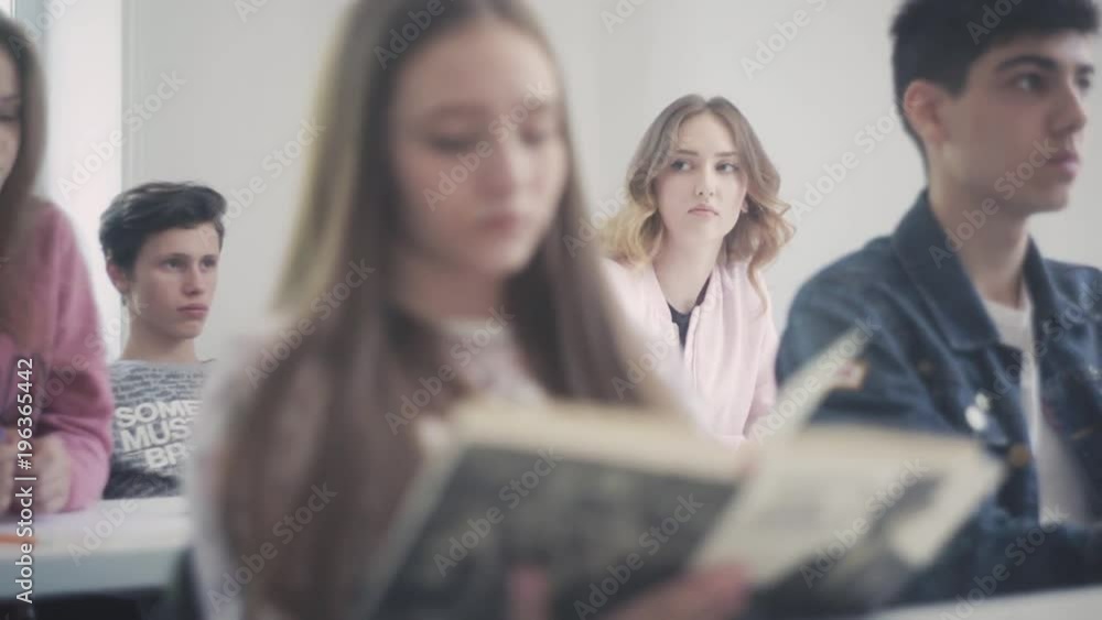 A girl sits in class and looks into the distance A girl sits in class and looks into the distance