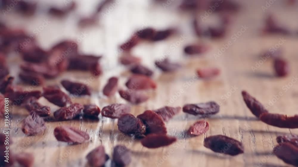 Bunch of Goji-Berries authentic Slow-Motion falling on wooden table, close up Bunch of Goji-Berries authentic Slow-Motion falling on wooden table, close up