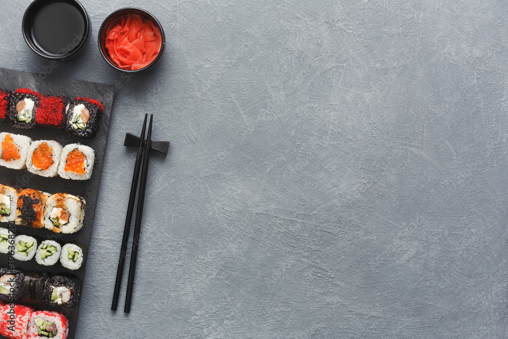 Set of sushi maki and rolls on grey background Set of sushi maki and rolls on grey background