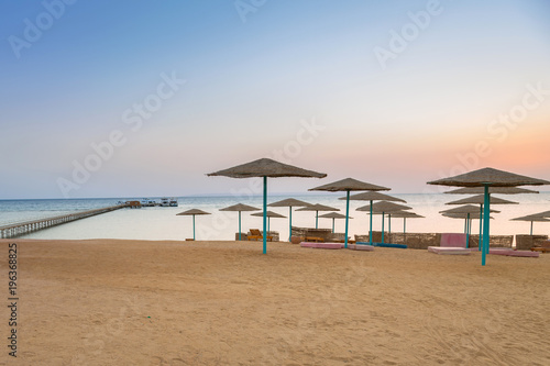 Parasols on the beach of Red Sea in Hurghada at sunrise  Egypt