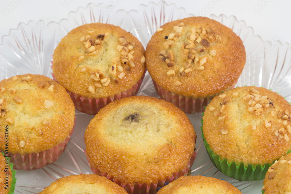 Fresh homemade delicious muffins,cupcake,banana cake with dried nuts isolated on white background.