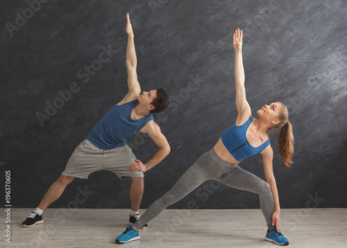 Fitness couple warmup stretching training indoors