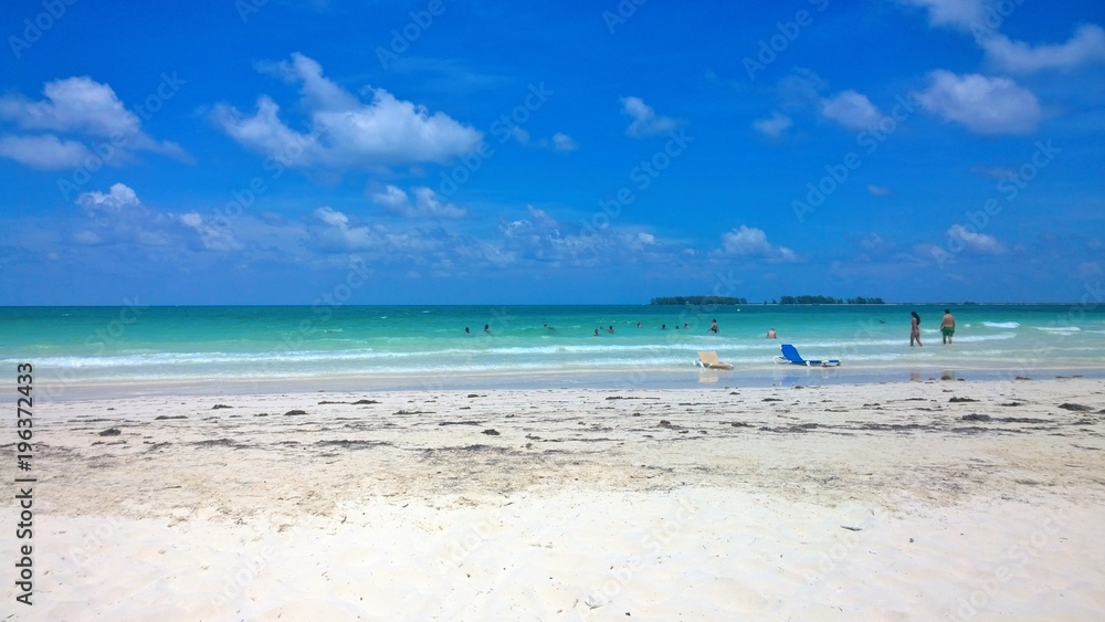 Ocean view of blue sky, beautiful clouds and pacific crystal turquoise water beside a tropical island with powdery white sand . Cayo Guilermo , Cuba Ocean view of blue sky, beautiful clouds and pacific crystal turquoise water beside a tropical island with powdery white sand . Cayo Guilermo , Cuba