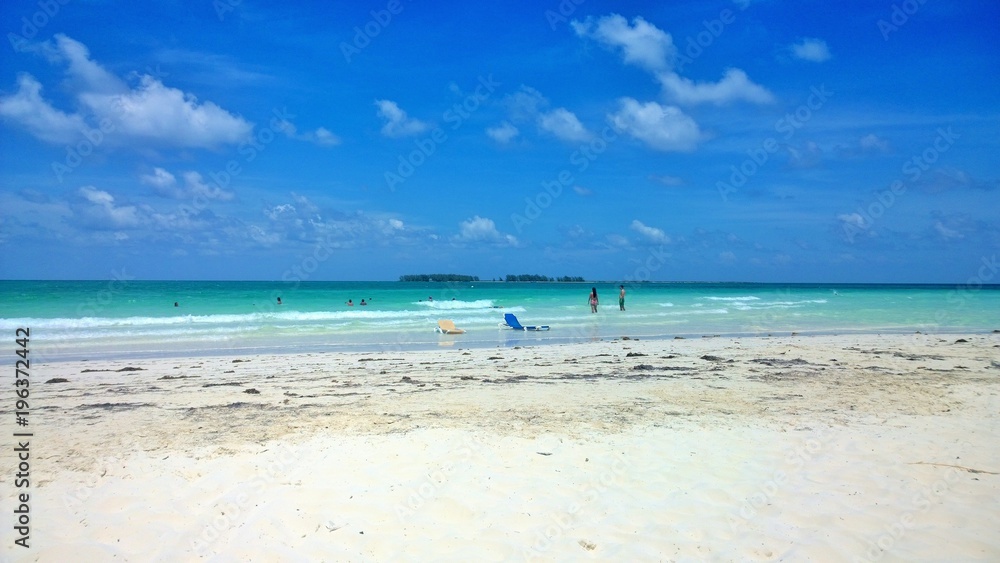 Ocean view of blue sky, beautiful clouds and pacific crystal turquoise water beside a tropical island with powdery white sand .  Cayo Guilermo , Cuba 