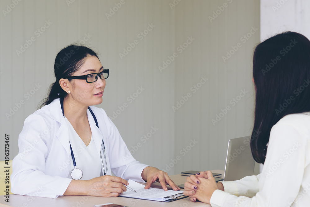 Female doctor checking patient health.According to the primary health insurance. medical health insurance concept Female doctor checking patient health.According to the primary health insurance. medical health insurance concept