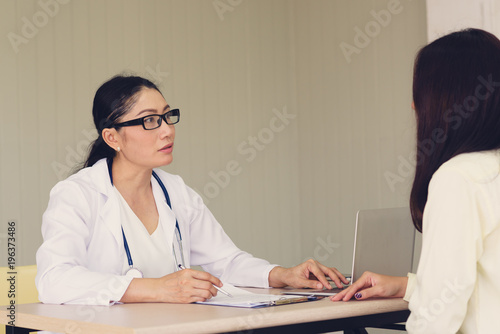 Female doctor checking patient health.According to the primary health insurance. medical health insurance concept