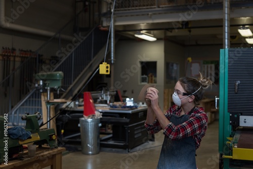 Female carpenter working in workshop photo