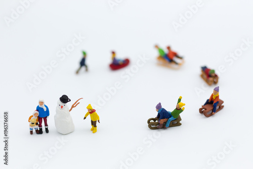 Miniature people: Children playing on snow funny together. Image use for Christmas festival