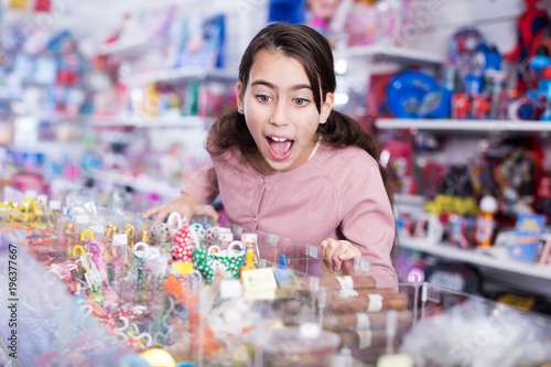 girl with open mouth buying sweet candies