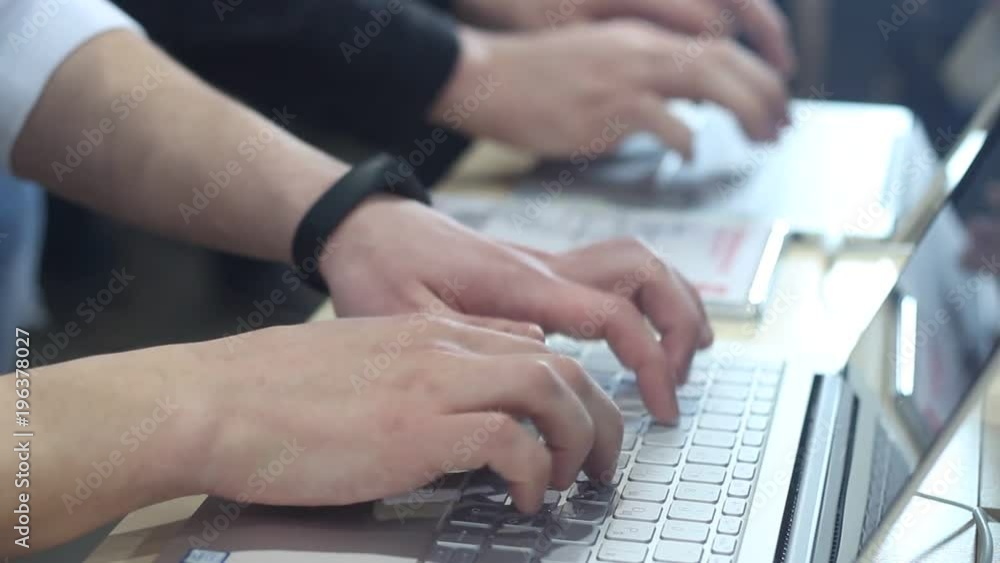 Businessman typing on laptop in modern office. Businessman typing on laptop in modern office.