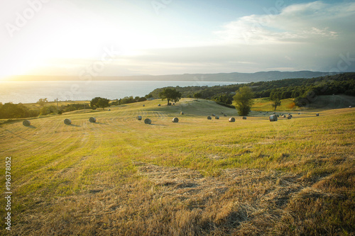 Beautiful light of the morning sun in the italian landscape and round bales