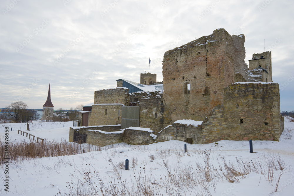 Ruins of the medieval castle of the Livonian knightly award close up in the cloudy March afternoon. Rakvere, Estonia