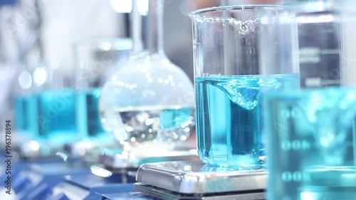 Scientist mixing chemicals in erlenmeyer flask