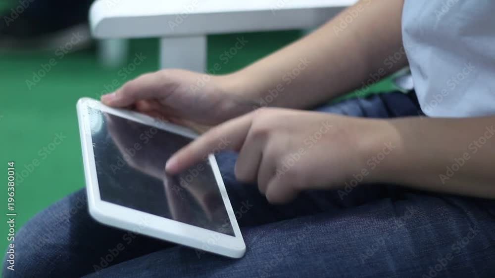 Business woman enjoys a tablet and a smartphone. Printing on a modern laptop at an exhibition of advanced technologies and innovations. Upgraded gadgets for young people. Business woman enjoys a tablet and a smartphone. Printing on a modern laptop at an exhibition of advanced technologies and innovations. Upgraded gadgets for young people.