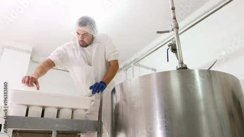 making  cheese- Working in diary Cheese factory, photo