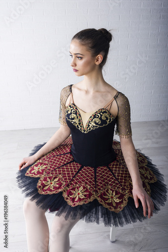 Yooung ballerina sitting on the chair and concentrate for performans photo