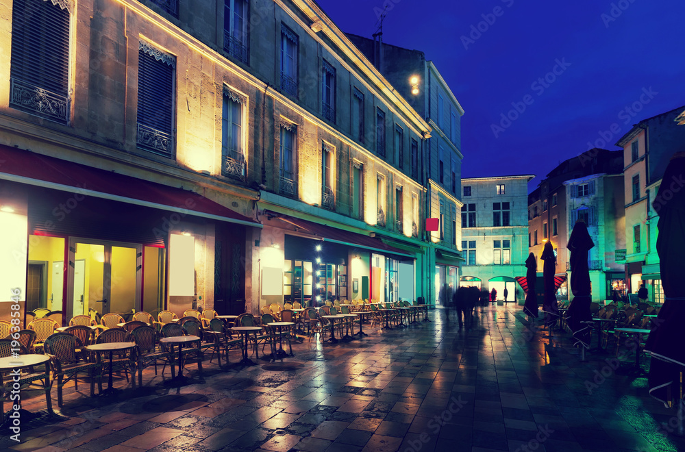 Night view of Nimes streets and building illuminated at dusk