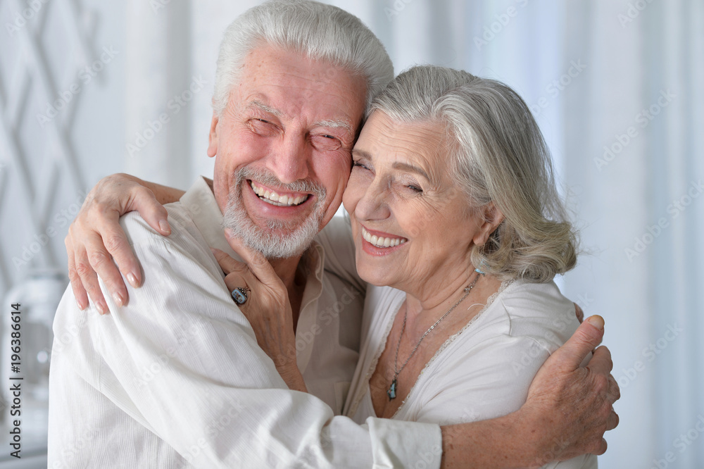 happy senior couple hugging  at home