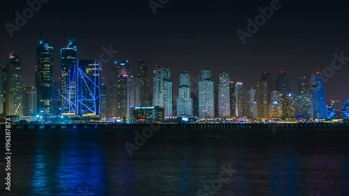 Scenic view of Dubai Marina Skyscrapers, night skyline, View from Palm Jumeirah, time lapse, United Arab Emirates. photo