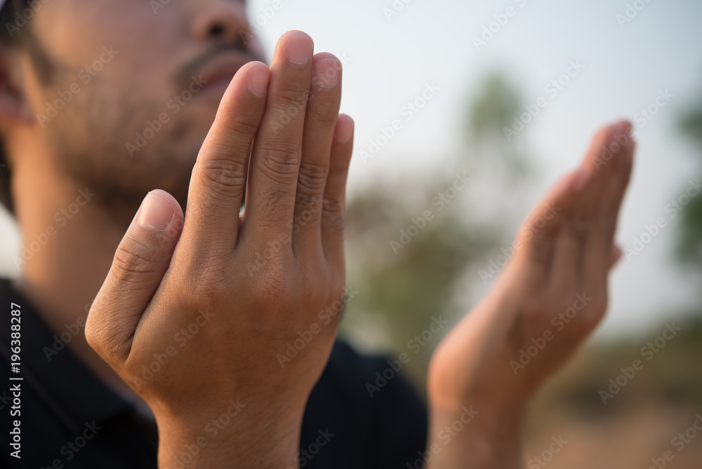 Silhouette Young asian muslim man praying on sunset,Ramadan festival concept Silhouette Young asian muslim man praying on sunset,Ramadan festival concept