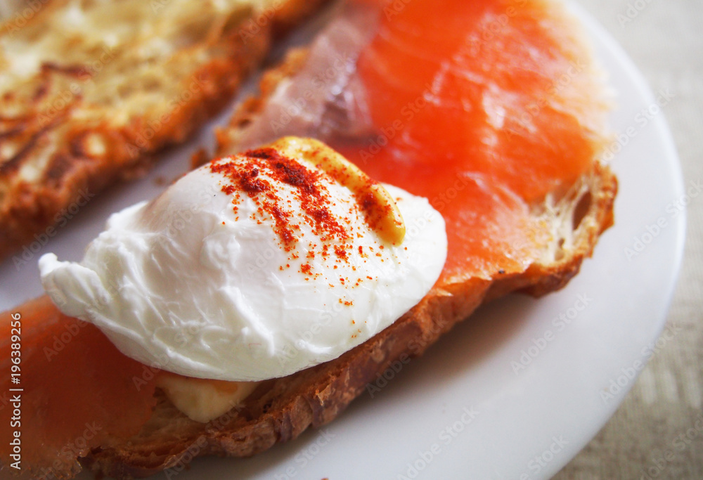 Poached eggs on toast with watercress and pepper.