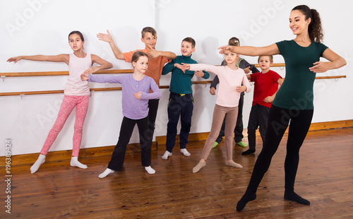 Group of children practicing at the ballet barre