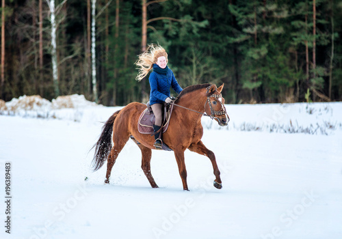 Happy young lady riding a horse. © Osetrik