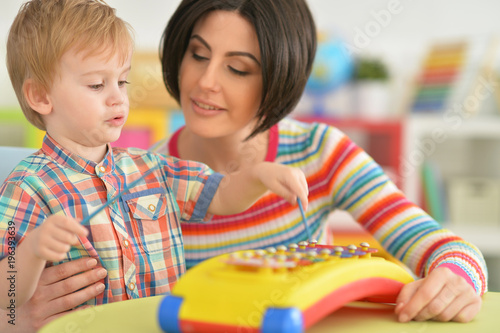 Young mother playing with son