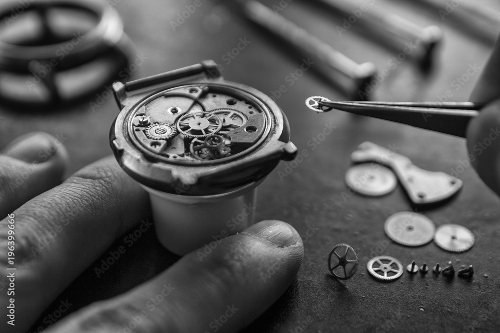 Watchmaker is repairing the mechanical watches in his workshop Watchmaker is repairing the mechanical watches in his workshop