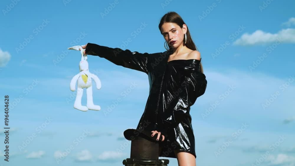 Magician girl making magic. Rabbit in a hat. Illusionist pull a rabbit ...