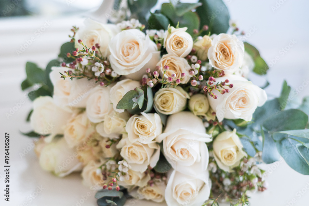 Tender beautiful wedding bouquet closeup,  peach color roses and decoration, selective focus