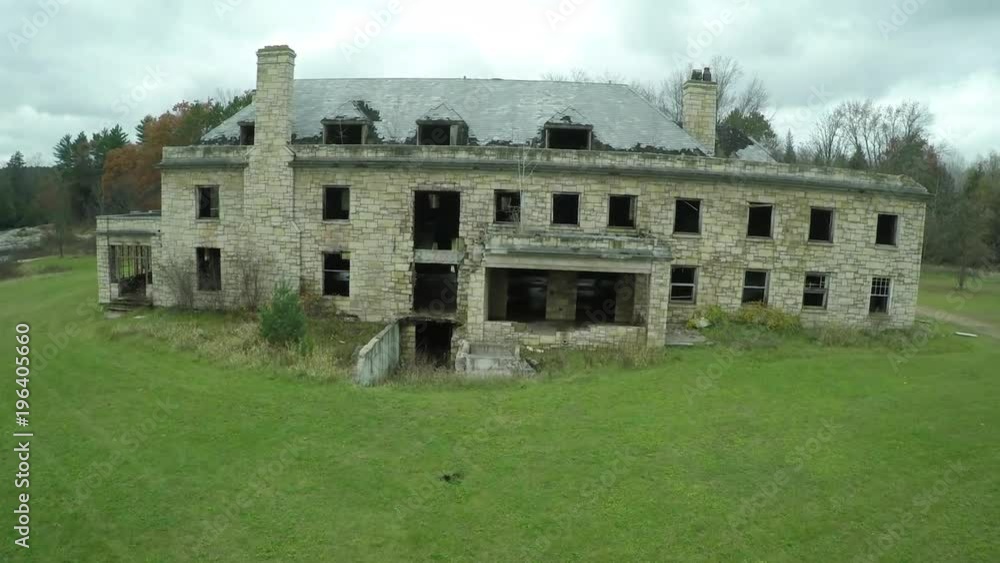 A rising aerial over a spooky abandoned mansion in the countryside. A rising aerial over a spooky abandoned mansion in the countryside.