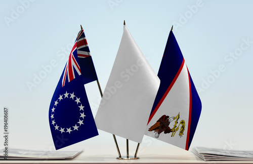 Flags of Cook Islands and American Samoa with a white flag in the middle photo