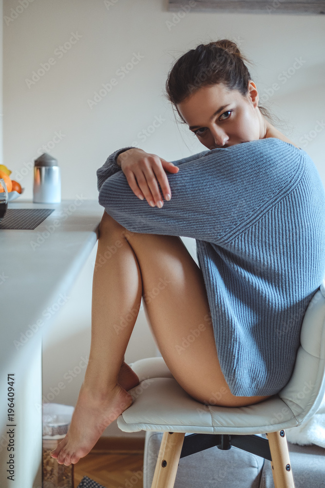 Sexy girl in a sweater sitting on bar chair Stock Photo | Adobe Stock