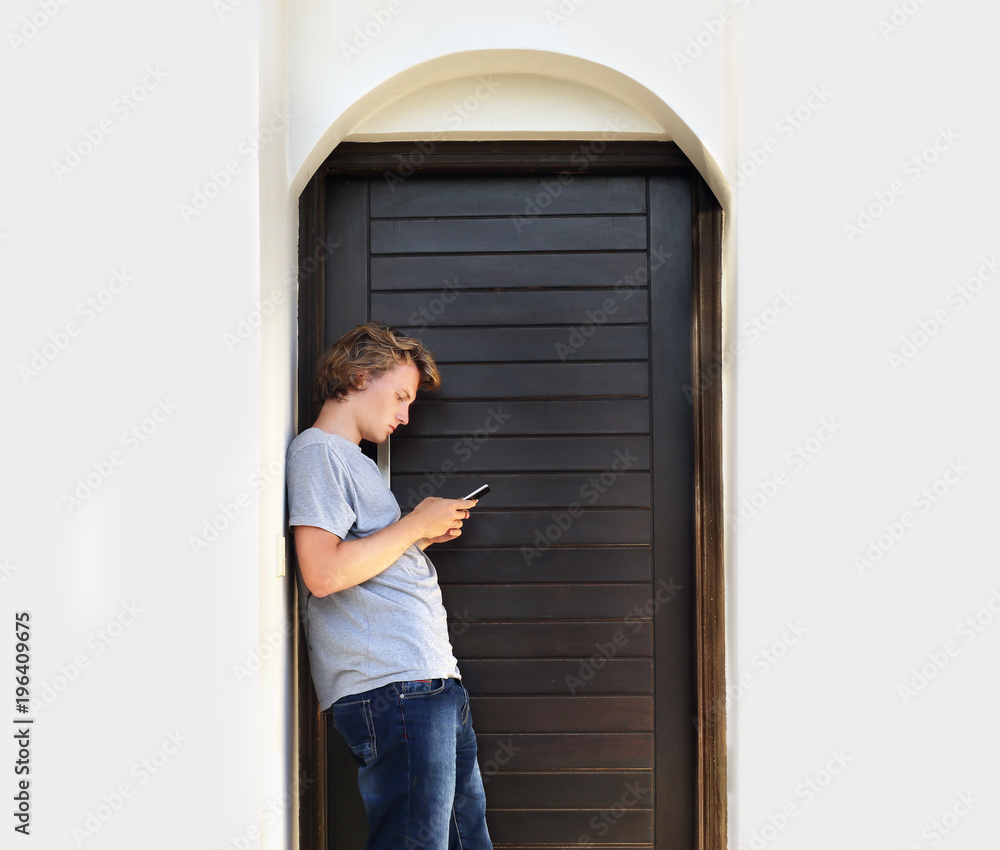Teenage boy typing text message.Using smart phone.