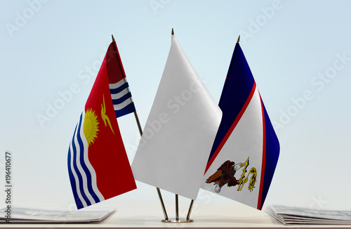 Flags of Kiribati and American Samoa with a white flag in the middle photo