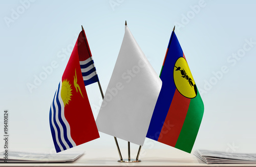 Flags of Kiribati and New Caledonia with a white flag in the middle photo